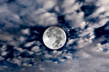 Full moon and blurred clouds on the sky.