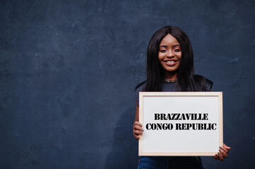 African woman hold white board with Brazzaville Republic of the Congo inscription. Most populous...