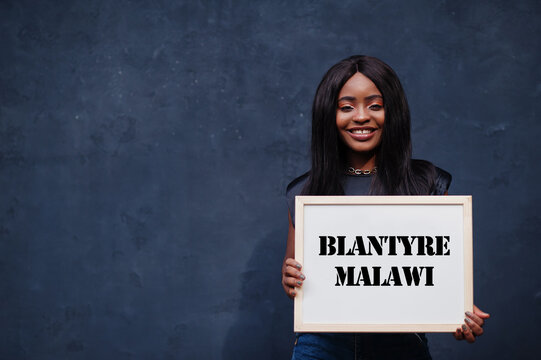 African woman hold white board with Blantyre Malawi inscription. Most populous city in Africa concept.