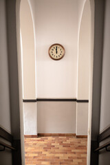 A clock on the portal of a house.