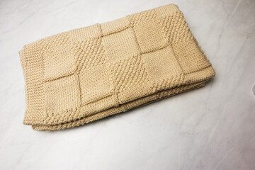 Homemade kniteed newborn paid on light background