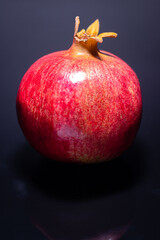 Juicy pomegranate on a dark background