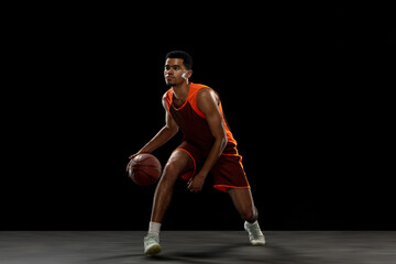 Winner. Young purposeful african-amrican basketball player training, practicing in action, motion...