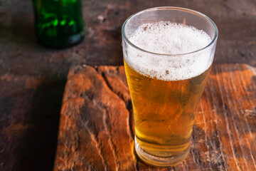 Beer mugs and beer bottles on a wooden table