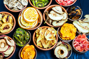 Organic Healthy Assorted Dried Fruit Mix close up. Dried fruit snacks. dried apples, mango, feijoa, dried apricots, prunes top view