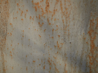 Rust.Old blue painted wall with rust spots.Textured rusty metal background. Rust stains through the cracked blue paint.
