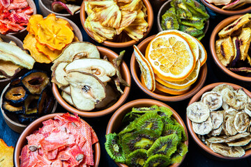 Organic Healthy Assorted Dried Fruit Mix close up. Dried fruit snacks. dried apples, mango, feijoa, dried apricots, prunes top view