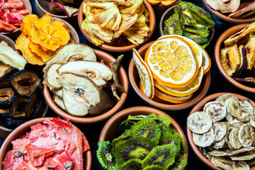 Organic Healthy Assorted Dried Fruit Mix close up. Dried fruit snacks. dried apples, mango, feijoa, dried apricots, prunes top view