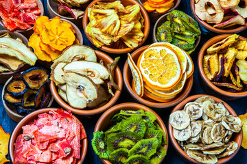Organic Healthy Assorted Dried Fruit Mix close up. Dried fruit snacks. dried apples, mango, feijoa, dried apricots, prunes top view
