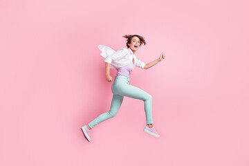 Fototapeta na wymiar Full body portrait of jumping running lady enjoy activity open mouth good mood isolated on pink color background