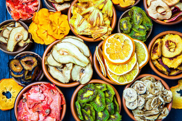 Organic Healthy Assorted Dried Fruit Mix close up. Dried fruit snacks. dried apples, mango, feijoa, dried apricots, prunes top view