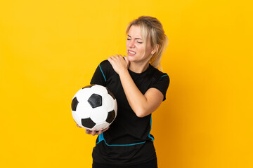 Young Russian football player woman isolated on yellow background suffering from pain in shoulder for having made an effort