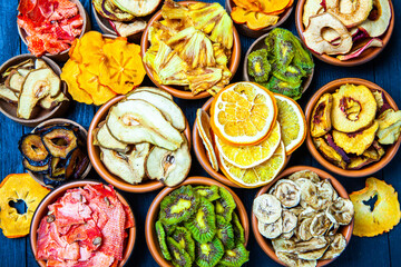 Organic Healthy Assorted Dried Fruit Mix close up. Dried fruit snacks. dried apples, mango, feijoa, dried apricots, prunes top view