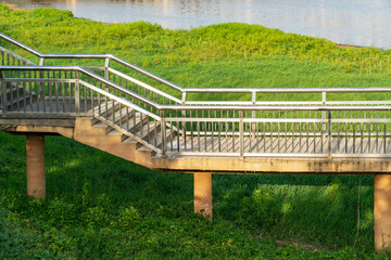 Wooden bridge over little river in city park
