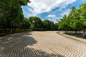 Empty street at the nice and comfortable great garden under lovely blue sky
