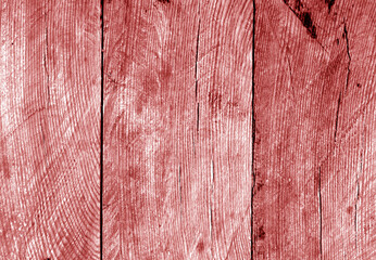 Wall made of uncutted weathered wood boards in red tone.