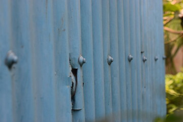A wall made of Corrugated Galvanized Iron (GCI) sheet and nuts