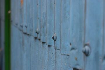 A wall made of Corrugated Galvanized Iron (GCI) sheet and nuts