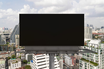 Blank black road billboard with Bangkok cityscape background at day time. Street advertising poster, mock up, 3D rendering. Front view. The concept of marketing communication to promote or sell idea.