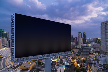 Blank black road billboard with Bangkok cityscape background at night time. Street advertising poster, mock up, 3D rendering. Side view. The concept of marketing communication to promote idea.