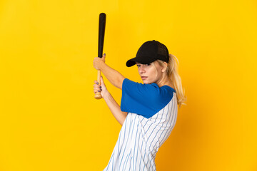 Young Russian woman isolated on yellow background playing baseball