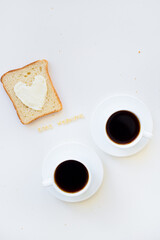 sandwich for breakfast in form of heart with cheese - good morning sign and two coffee cups