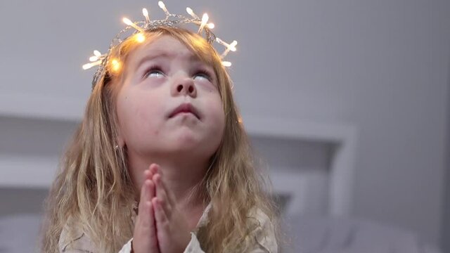 charming little girl with garland on head like a crown. new year, childhood, daughter, princess. FullHD footage