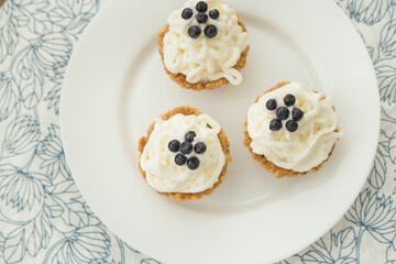 Homemade cupcake with blueberries, cream and fresh berries