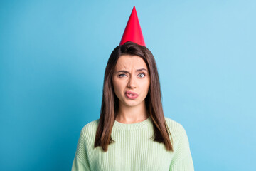 Photo portrait of disgusted woman wearing red cone isolated on pastel blue colored background