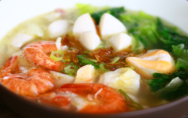 Tom yam soup on wood background.