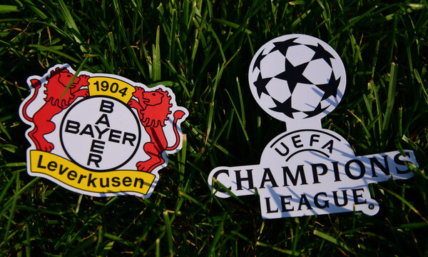 September 6, 2019 Istanbul, Turkey. The emblem of the German football club Bayer Leverkusen next to the logo of the Champions League on the green grass of the football field.