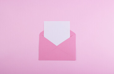 Envelope with a red heart for Valentine's Day on a pink background