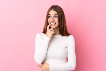 Young woman over isolated pink background nervous and scared