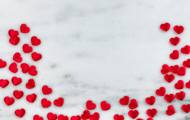 Red lovely hearts on marble stone in flay lay composition for Valentines Day concept