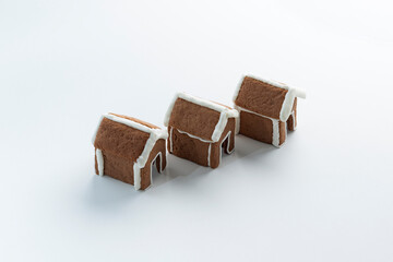 Glazed painted gingerbread houses on white background. Winter Holiday pattern. Copy space