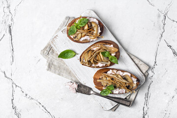 Tasty sandwiches with golden needle mushroom or enoki, fried champignon, soft cheese and basil