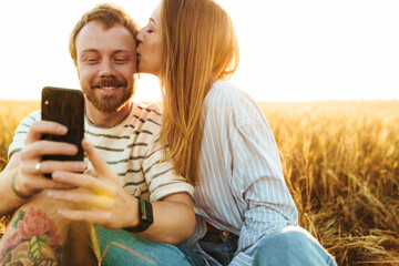 Loving couple taking a selfie by mobile phone