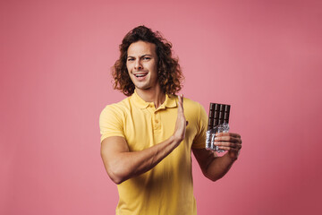 Serious man refusing eating chocolate isolated