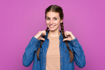 Young woman over isolated purple background proud and self-satisfied