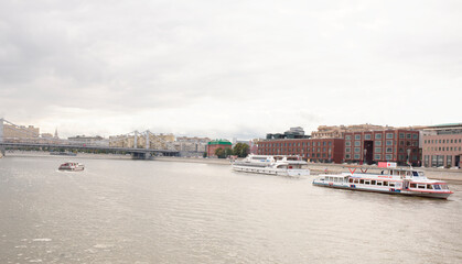 Fototapeta premium Passenger vessels with tourists on board float on the Moscow-river