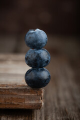 Fresh blueberries on rustic wooden table.