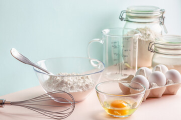 Cooking ingredients for dough, eggs, flour, sugar.
