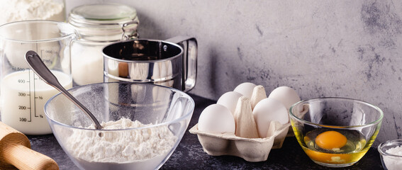 Cooking ingredients for dough, eggs, flour, sugar, milk.