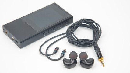 In-ear headphones for Hi-Fi music player. Audio sound and modern equipment for music lovers and audiophiles