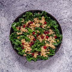 Healthy raw kale and quinoa salad with cranberry and pine nut.