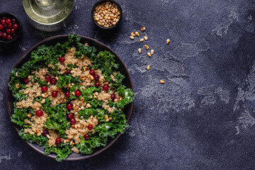 Healthy raw kale and quinoa salad with cranberry and pine nut.