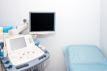 Interior of examination room with ultrasonography machine in hospital laboratory. Modern medical equipment background.