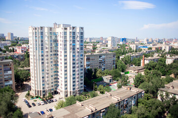 Russia, Volgograd, 07.13.2020: High multi-storey modern residential building. View from a height of...