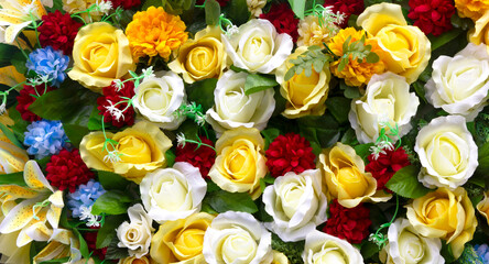 Artificial colorful rose flowers background.