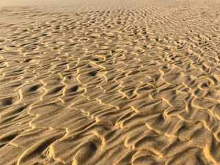 Wave patterns on the beach sand in close-up